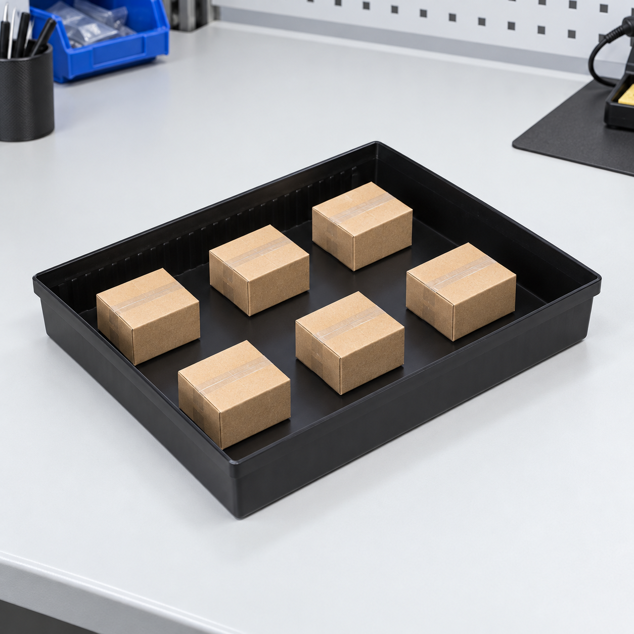 Black ESD tray with evenly spaced plain dummy packages illustrating distributed load placement