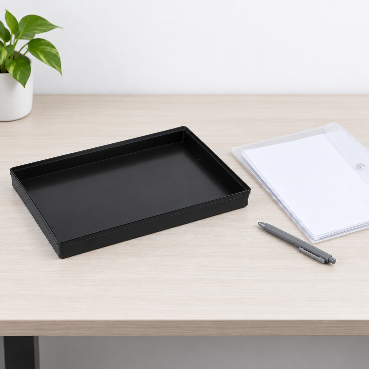 Empty black ESD tray next to a separate blank document folder