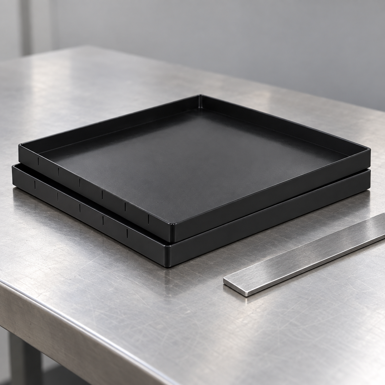 Two shallow black ESD trays offset for a rim-alignment inspection