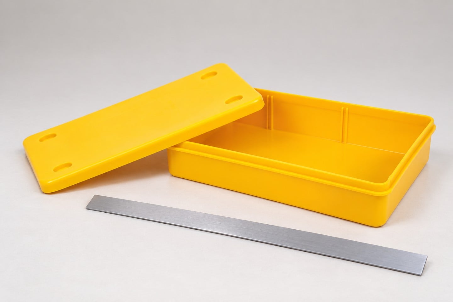 Yellow SWESD bin base and rim beside a separate straightedge