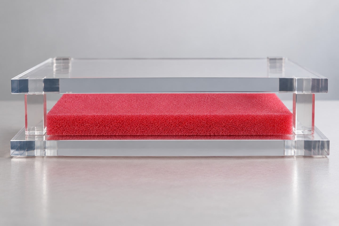 Pink-red SWESD foam sheet between plain plates in a fixture planning illustration