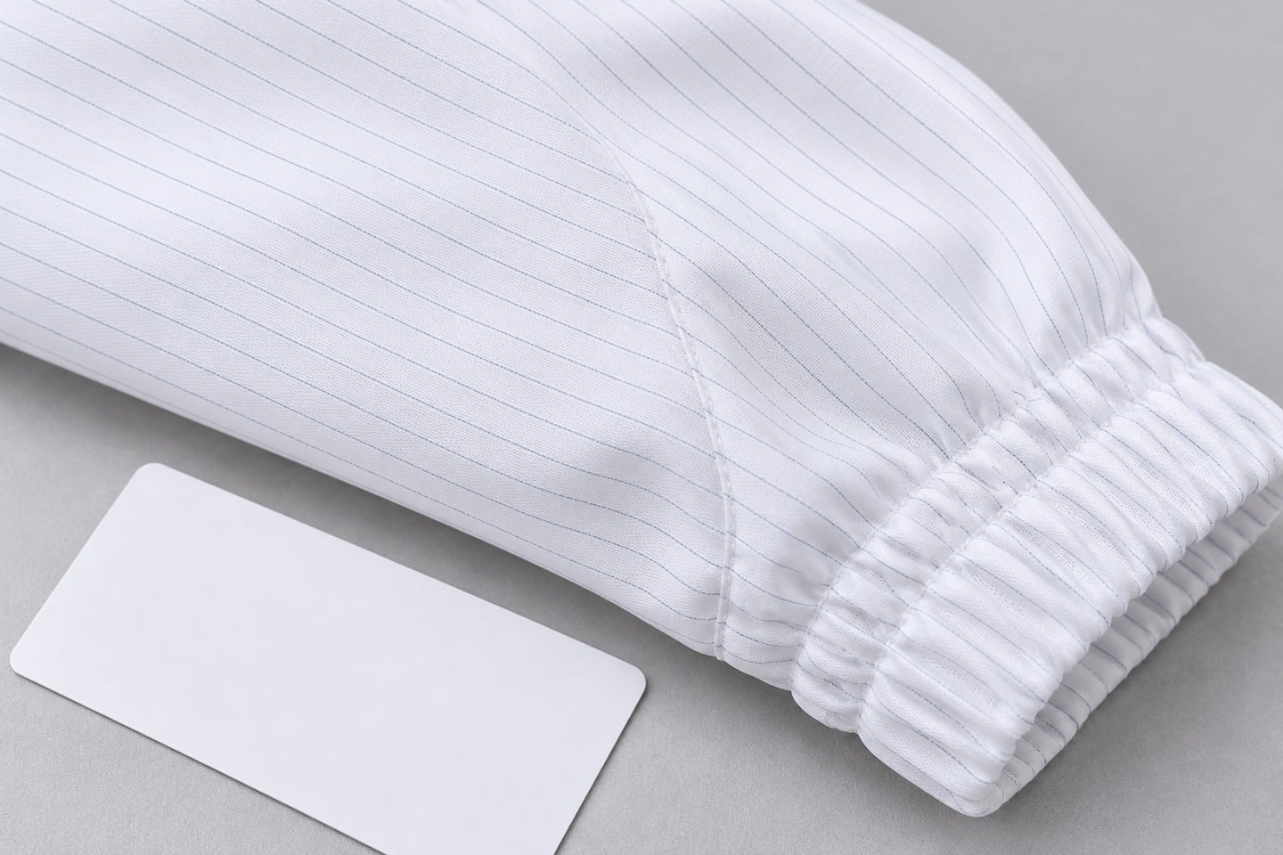 White cleanroom garment seam and elastic cuff detail