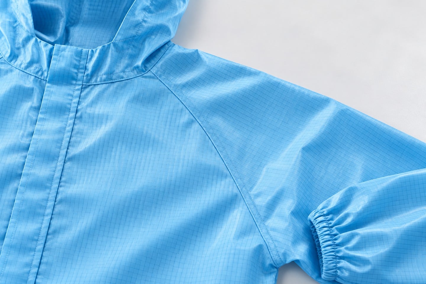 Blue cleanroom garment shoulder and sleeve seam detail