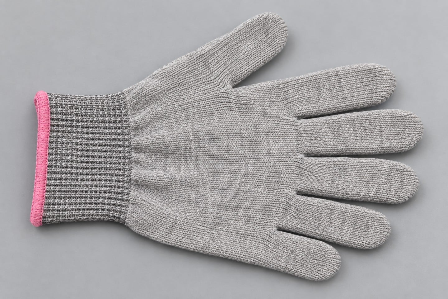 Knit material and ribbed pink-edged cuff of a SWESD glove