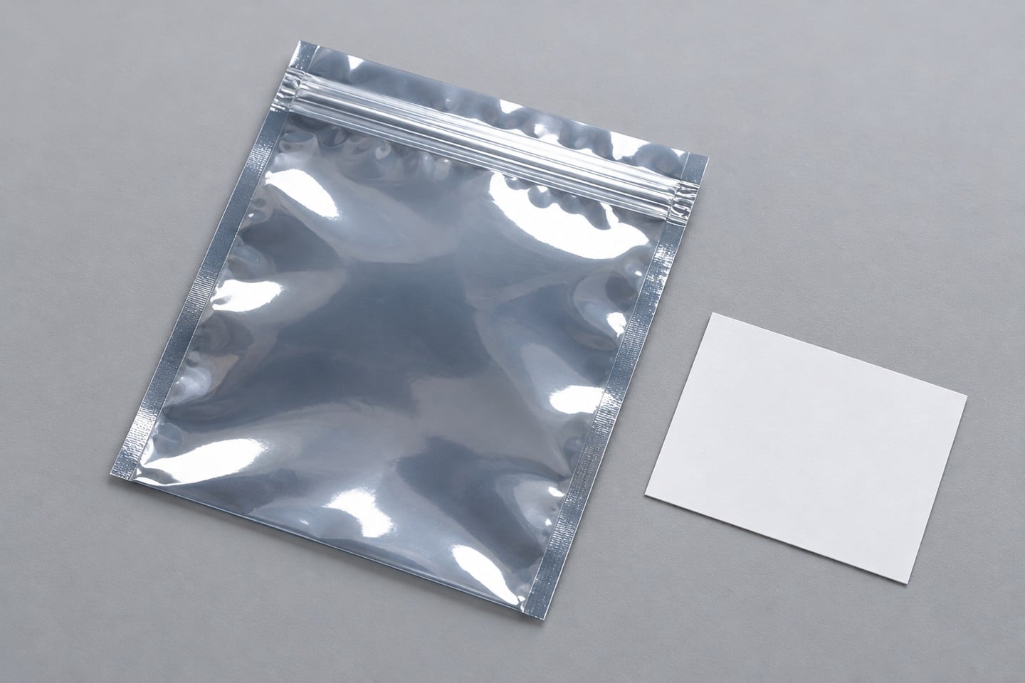 Closed SWESD shielding bag zipper and edge beside a blank sample identity card