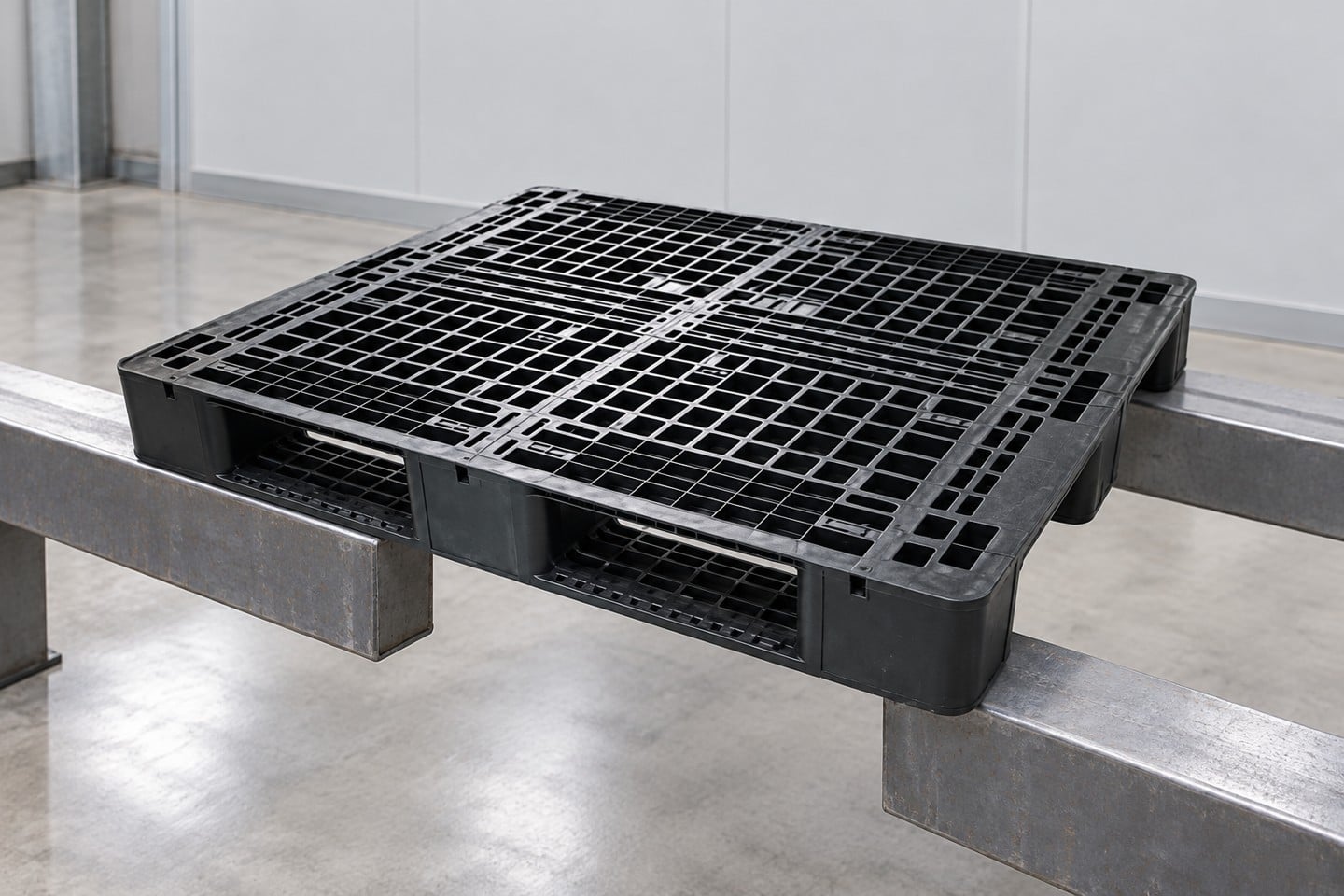 Unloaded black logistics pallet on two illustrative steel supports