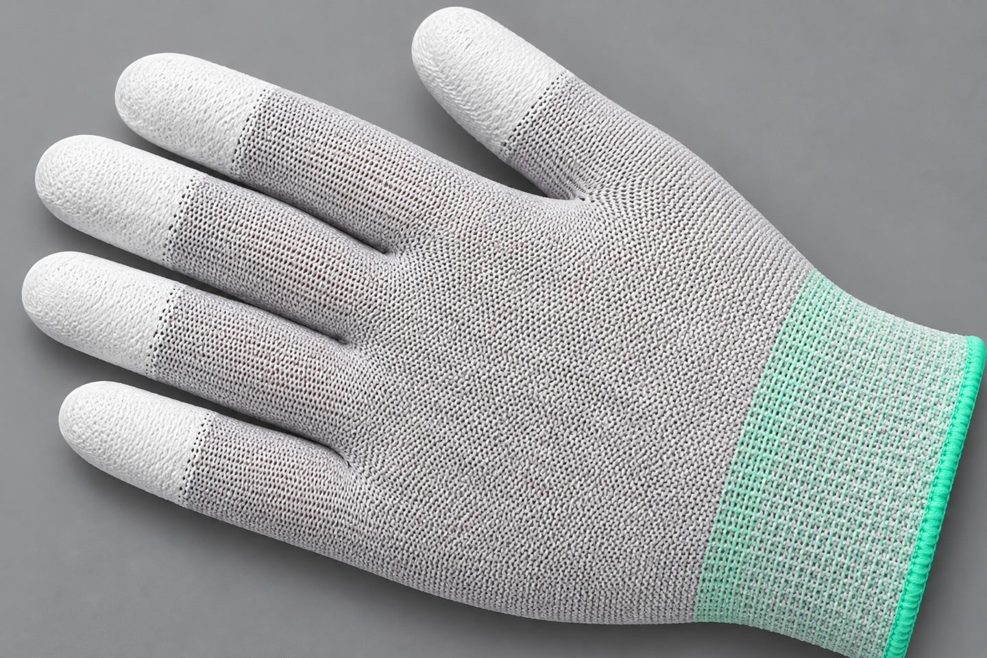 White fingertip coating transitions into gray knit glove fabric