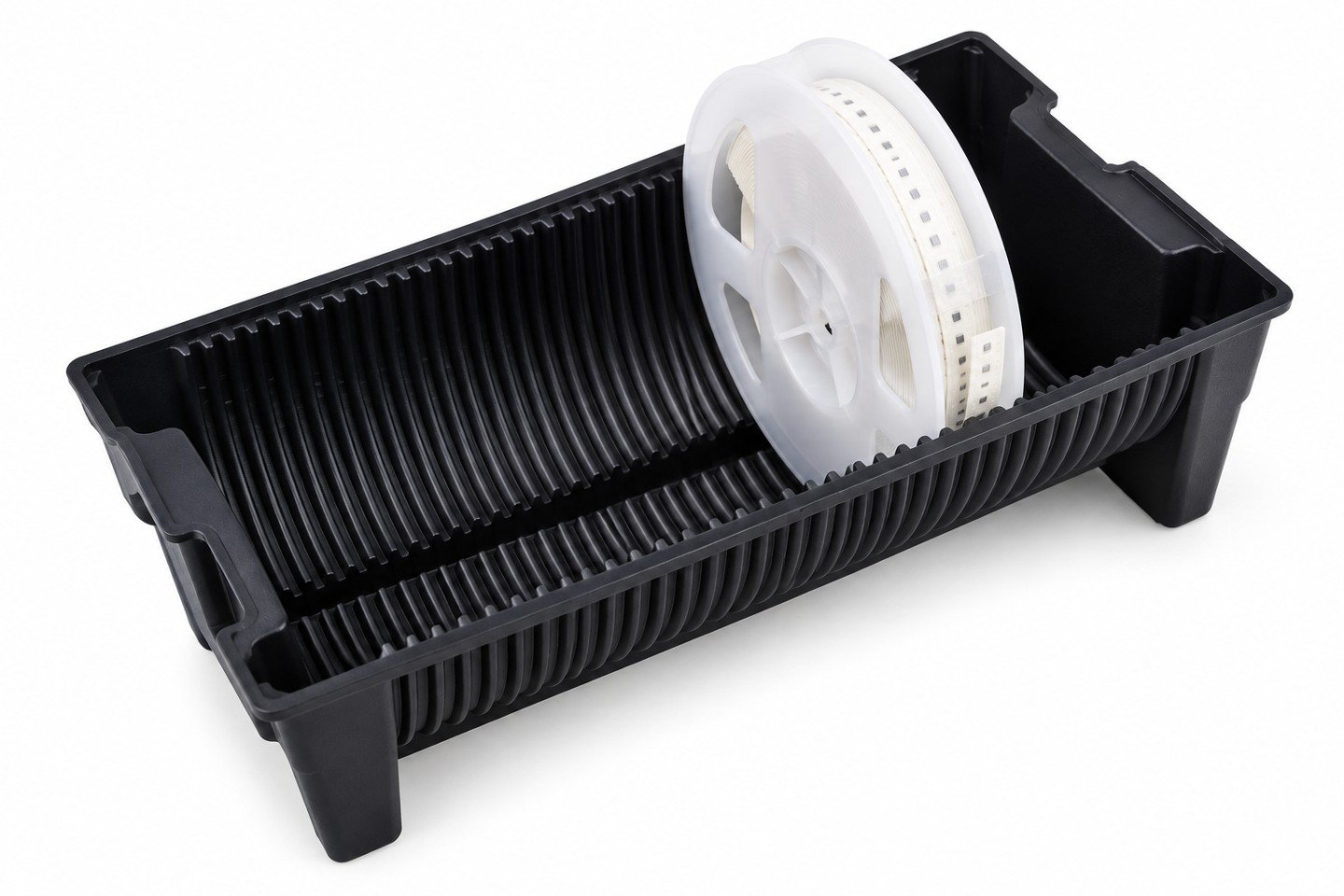 White reel flange seated in the curved support of a black carrier